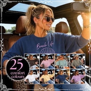 May include: A navy blue crewneck sweatshirt featuring the text Beach Life and a shell graphic in pink. The image includes a grid displaying the sweatshirt in 25 different colors, including white, pink, light blue, yellow, and lavender.