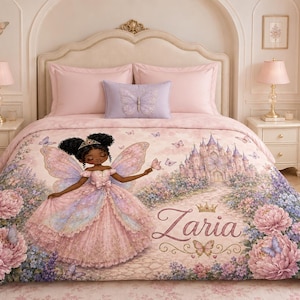 May include: A bedding set featuring a fairy princess with dark skin and curly hair wearing a pink gown with wings. The design includes a castle, butterflies, and large pink flowers. The name Zaria is printed in cursive script with a gold crown.