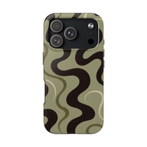 May include: A smartphone case featuring a wavy, abstract pattern in shades of sage green, dark brown, and cream. The design consists of fluid, vertical lines that curve across the surface, surrounding a black camera module with three lenses.