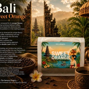 May include: A white coffee bag with a label featuring a Balinese temple, a person carrying a fruit basket, and the text "SWEET ORANGE". The bag is surrounded by a bowl of roasted coffee beans, a cup of black coffee, and a white frangipani flower.