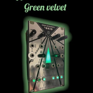 May include: A silver-colored synthesizer module with a green LED triangle in the center. The module is labeled "Liquid Glitcher" and "Error Instruments".