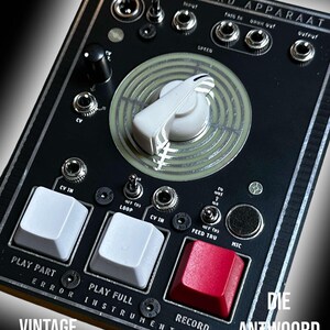 May include: A black and silver electronic music sampler with the text "LOFI CV CONTROL SAMPLER / FILTER" and "WOORD APPARAAT" on the front. The sampler has a large knob, several buttons, and a red record button.