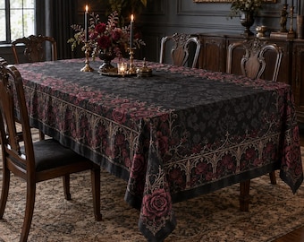 May include: A rectangular tablecloth featuring a dark black base with a repeating damask pattern and a decorative border of deep red roses and gold-toned gothic arches. The fabric drapes over a dining table surrounded by wooden chairs.