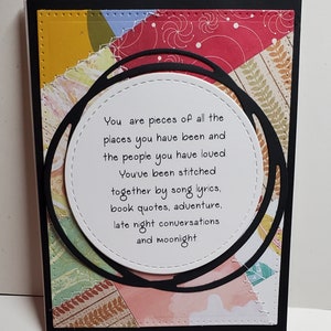 May include: A white card with a black circle and a quote inside. The quote reads: "You are pieces of all the places you have been and the people you have loved. You've been stitched together by song lyrics, book quotes, adventure, late night conversations and moonlight."
