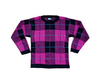 May include: A pink and black plaid sweater with blue accents.