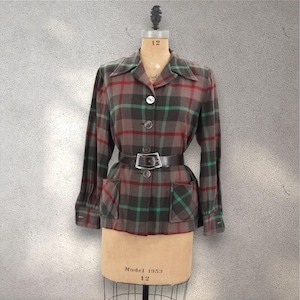 May include: A brown, green, and red plaid jacket with a button-up front and two patch pockets. The jacket has a black leather belt with a silver buckle.