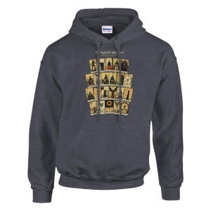 May include: A dark charcoal gray hooded sweatshirt featuring a graphic print of The Major Arcana tarot cards arranged in a grid. The design includes various illustrated figures and symbols on aged-looking cards with the text The Major Arcana.