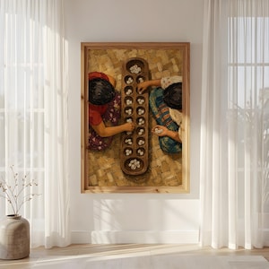 May include: A framed wall art print depicting two individuals playing a traditional mancala board game with cowrie shells. The wooden board features multiple circular indentations filled with white shells, set against a woven mat background.