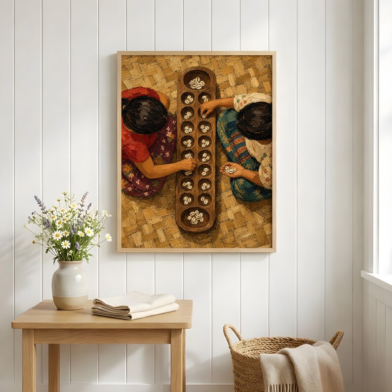 May include: A framed wall art print depicting two individuals playing a traditional mancala board game with cowrie shells on a woven mat. The artwork features warm earth tones, detailed textures of the game board, and patterned clothing.