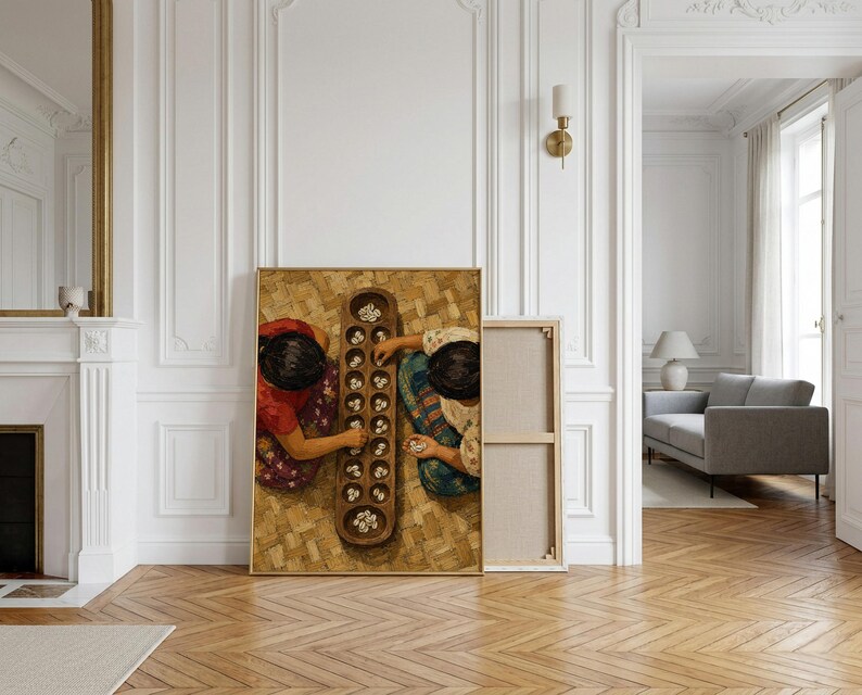 May include: A framed canvas print depicting two individuals from a top-down perspective playing a traditional board game with small white stones on a long, carved wooden board with multiple circular indentations, set on a woven mat surface.
