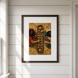 May include: A framed wall art print depicting two individuals playing a traditional board game with a long wooden board containing multiple circular indentations filled with small white cowrie shells, set against a textured woven background.