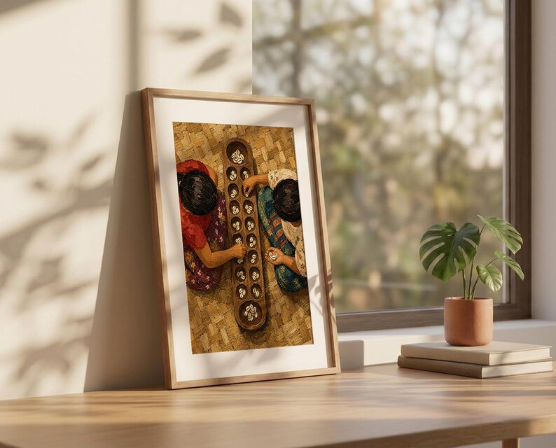 May include: A framed wall art print depicting an overhead view of two individuals playing a traditional wooden mancala board game with small white stones. The board is elongated with two rows of circular pits, and the players are wearing patterned clothing.