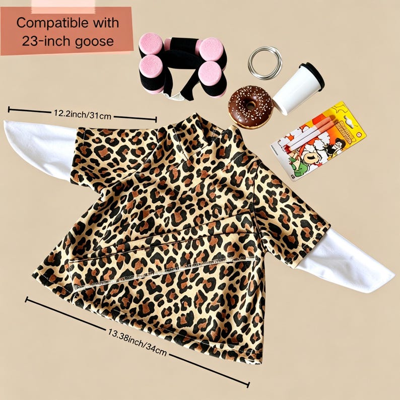 May include: A leopard print shirt with white sleeves, compatible with a 23-inch goose. Accessories include a black and pink dumbbell set, a chocolate frosted donut, a white cup, and a package of two pens. Dimensions are 12.2 inches and 13.38 inches.