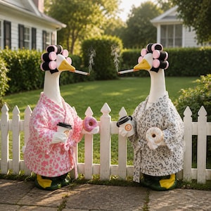 May include: Two white goose figurines wearing pink and grey leopard print robes, hair rollers, and holding coffee cups and donuts. Each goose has a cigarette in its beak with a thin wisp of smoke rising, standing in front of a white picket fence.