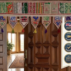 May include: A decorative door valance featuring a horizontal band of patchwork fabric with intricate embroidery, floral patterns, and elephant motifs. The valance has seven hanging triangular pennants, each adorned with colorful stitching and tassels.