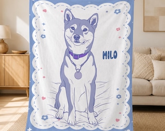 May include: A rectangular throw blanket featuring a purple and white illustration of a dog sitting upright. The dog wears a purple collar with a circular tag. The name MILO is printed in purple. The border has a scalloped edge with small flowers.