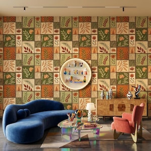 May include: A room featuring a curved blue sofa, a pink armchair, and a glass coffee table. A circular wall shelf displays small vases. The wall is covered in wallpaper with a repeating square grid pattern of botanical illustrations in green, orange, and tan.