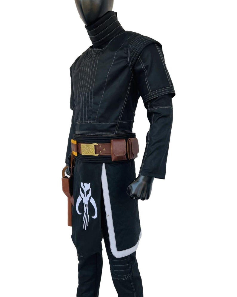 May include: A black tactical costume featuring a high-neck top with white stitching, a brown utility belt with pouches and a gold buckle, and a black skirt-like overlay with a white skull emblem and light gray trim, worn over black trousers.