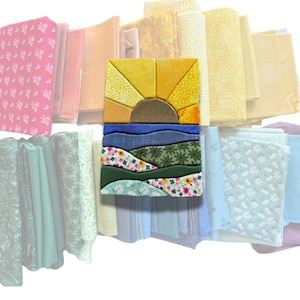 May include: A rectangular fabric art piece featuring a sun rising over a landscape of rolling hills and floral patterns, layered over a collection of folded fabric swatches in various shades of pink, yellow, blue, green, and white.