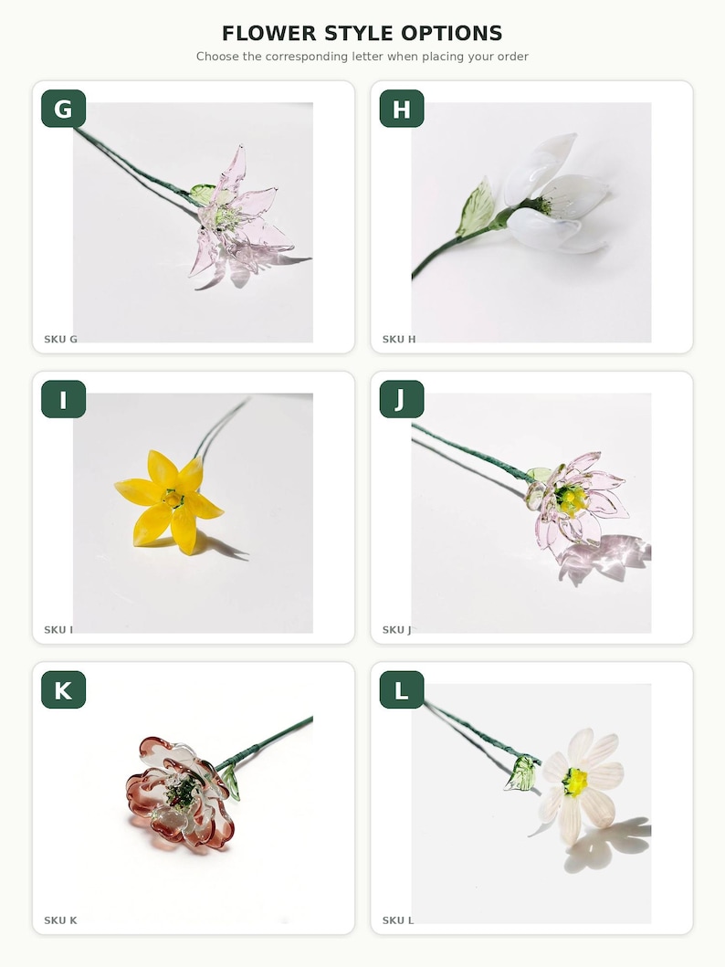 May include: A collection of six glass flower stems labeled G through L. Each stem features a unique glass bloom in colors including pink, white, yellow, and red, attached to a thin green wire stem with small green glass leaves for display.