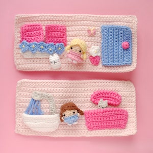 May include: Two crocheted panels with a pink background and various crocheted figures. The top panel features a blue door, a butterfly, a flower, a white bunny, and a girl with blonde hair. The bottom panel features a shower, a girl with brown hair, a pink bed, and a mushroom.