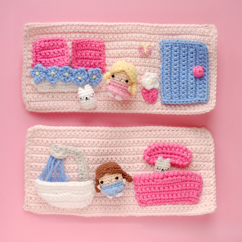 May include: Two crocheted panels with a pink background and various crocheted figures. The top panel features a blue door, a butterfly, a flower, a white bunny, and a girl with blonde hair. The bottom panel features a shower, a girl with brown hair, a pink bed, and a mushroom.