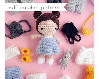 May include: Crochet doll pattern PDF with a crocheted doll wearing a blue dress and a variety of crocheted accessories, including a backpack, shoes, and a purse.