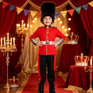 May include: A child wearing a red and black British royal guard costume, featuring a tall black bearskin hat, a red tunic with gold buttons and white trim, a white belt with a gold buckle, black trousers with red stripes, and black boots.