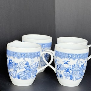 May include: A set of white ceramic mugs featuring a blue transferware-style pattern. The design depicts various creatures, including a large sea monster, a flying reptile, and a humanoid figure, integrated into a landscape with pagodas and trees.