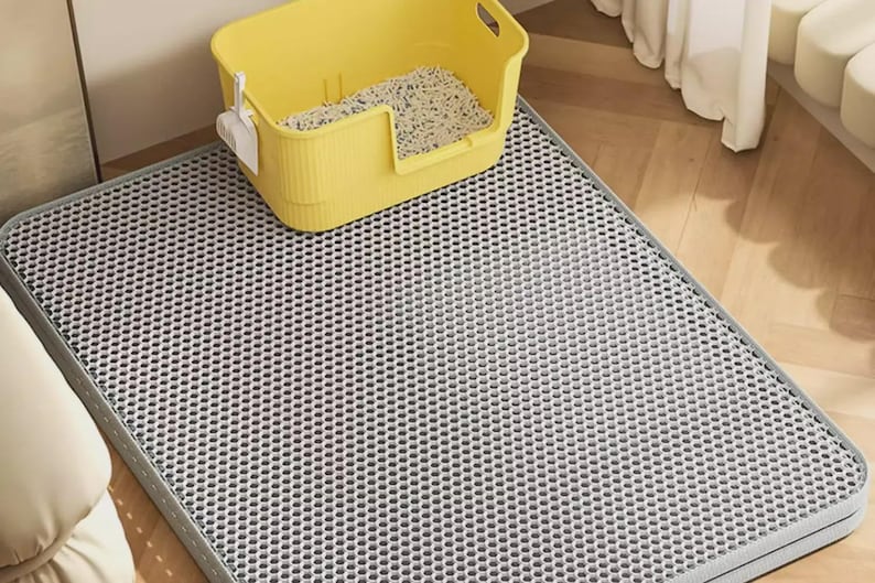 Extra Large Cat Litter Mat, waterproof double layer litter catcher mat designed to trap cat litter, sand, and debris. Durable honeycomb litter trapping surface collects scattered litter from cat paws while the waterproof bottom layer protects hardwood, tile, laminate, and carpet floors. Non-slip washable cat mat made from soft EVA material for maximum comfort and easy cleaning. Ideal litter box mat for indoor cats, multi-cat homes, pet own
