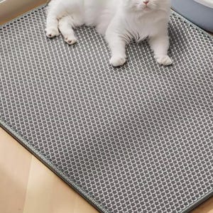 Waterproof Cat Litter Mat featuring a double-layer honeycomb structure for trapping scattered litter and cat sand. Non-slip backing keeps the mat securely in place while protecting hardwood, tile, laminate, and carpet flooring. Soft, paw-friendly EVA material offers comfort and durability. Ideal litter box accessory for indoor cats, multi-cat households, and pet owners seeking an easy-clean litter trapping solution.