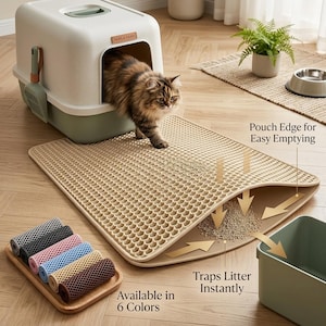 May include: A beige cat litter mat with a honeycomb surface texture, featuring a pouch edge for emptying trapped litter. A long-haired cat exits a white and sage green hooded litter box nearby. A wooden tray displays six rolled mats in various colors.