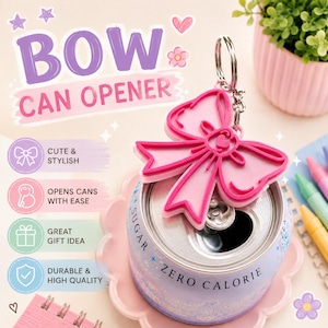 May include: A pink bow-shaped can opener keychain attached to a metal ring. The opener features a bright pink bow design with a darker pink outline. It is positioned on top of a light purple soda can labeled with the text SUGAR ZERO CALORIE.