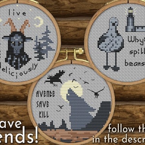 May include: Three embroidery hoops with different designs. The first hoop features a black goat with the text "live deliciously". The second hoop features a black bird with the text "avende save kill". The third hoop features a grey seagull with the text "Why'd ye spill yer beans?".