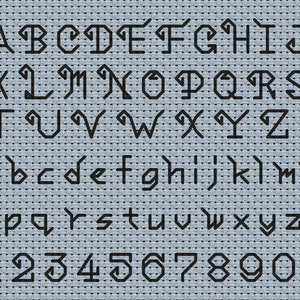 May include: A complete alphabet of uppercase and lowercase letters plus numbers zero through nine, rendered in a black geometric, angular font style. The characters are displayed in rows against a light blue, textured fabric background.