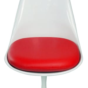 May include: A white, modern chair with a rounded back and a red cushion. The chair has a single, white, pedestal-style base. The seat cushion is oval-shaped and appears to be made of a smooth material.