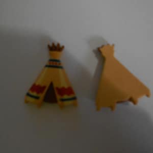 May include: Two small, yellow teepee-shaped objects. One is upright with red and blue decorative patterns. The other is a solid yellow shape. The objects are likely toys or decorative items.