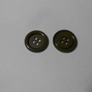 May include: Two green metal buttons with four holes each.