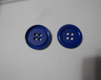 May include: Two blue plastic buttons with four holes each.