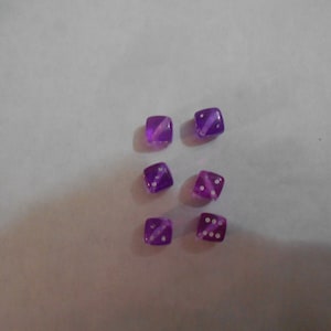 May include: Six purple dice with white dots. The dice are translucent and have a slight shimmer.