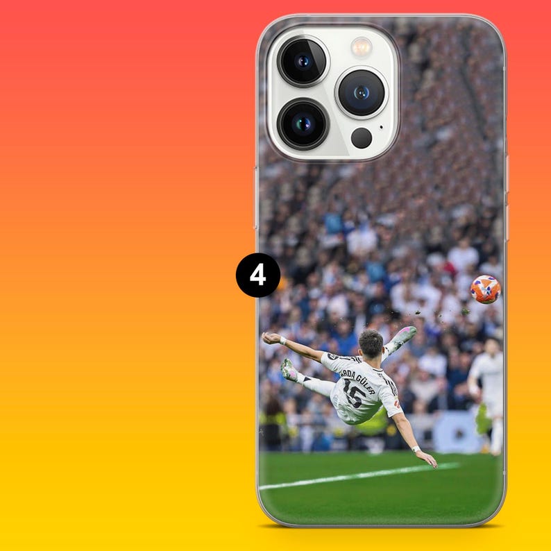 May include: A clear smartphone case featuring a printed graphic of a soccer player wearing a white jersey with the name G&Uuml;LER and the number 15 on the back, performing a bicycle kick on a green field in front of a blurred stadium crowd.