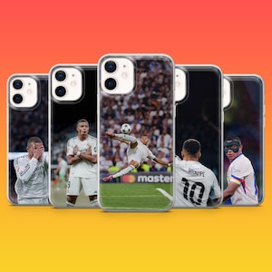 May include: Five clear phone cases featuring photographic prints of a football player in a white jersey. The designs show the athlete in various poses, including a bicycle kick, standing with arms crossed, and wearing a black protective face mask.