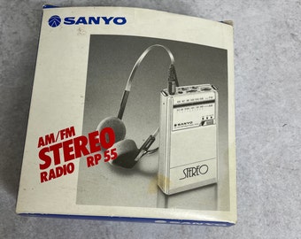 Vintage Sanyo RP 55 Am/FM stereo portable radio with headphones, box and unused strap