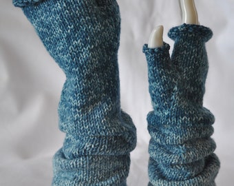May include: A pair of blue and white knitted fingerless gloves. The gloves are displayed on white mannequin hands. The gloves have a ribbed cuff and a textured, layered design on the arm. The color is a mix of blue and white.