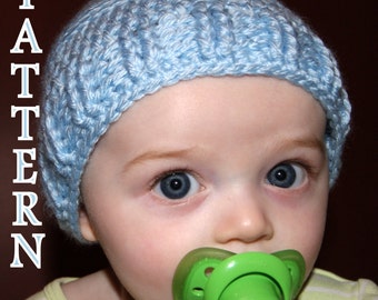 May include: A baby wearing a light blue knitted hat with a pacifier in their mouth.