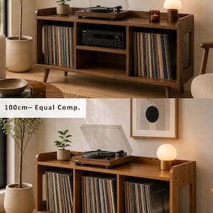 May include: A wooden media console with tapered legs, featuring three storage compartments for vinyl records. The top surface holds a turntable, a small potted plant, and a lamp. Text labels indicate 100cm- Central Shelf and 100cm- Equal Comp.