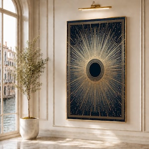 May include: A rectangular wall art piece featuring a dark navy blue background with a central black circle surrounded by concentric gold rings and radiating gold lines that extend toward the edges, all enclosed within a thin gold frame.