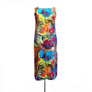 May include: A sleeveless maxi dress with a colorful floral print. The dress features a variety of flowers in shades of blue, red, orange, and yellow on a brown background.