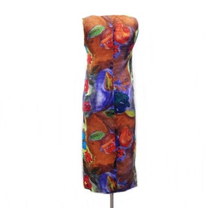May include: A sleeveless dress with a brown, blue, green, red, and yellow floral print. The dress is on a white background.