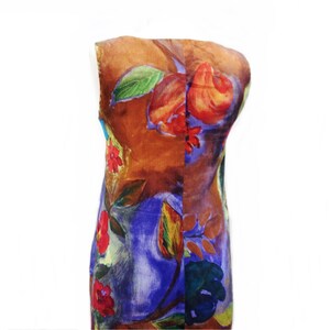 May include: A sleeveless dress with a colorful floral print. The dress has a brown background with red, orange, yellow, green, blue, and purple flowers.